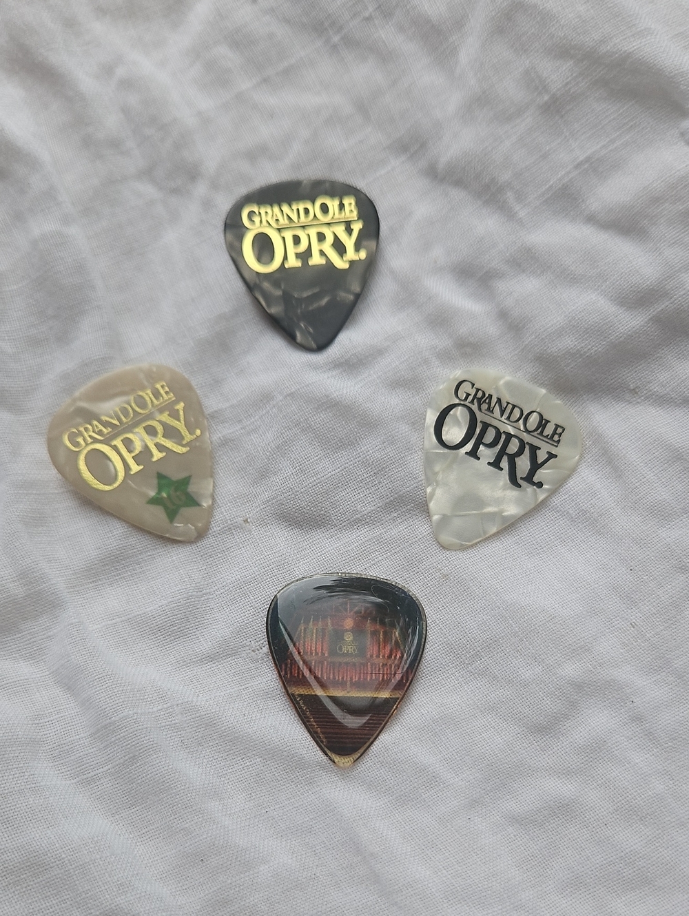 Four Collectible Plastic Guitar Picks featuring the Iconic Grand Ole Opry